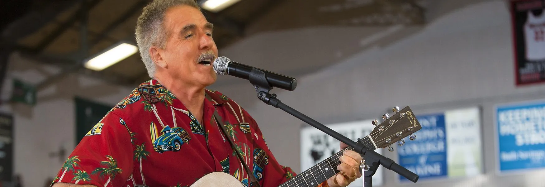 Rick Charette singing and playing guitar on stage